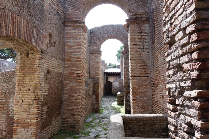 Ancient Ostia Antica Semi-Private Day Trip from Rome by Train with Guide - The Guided Walk on Decumanus Maximus, Civic Buildings, and Shops