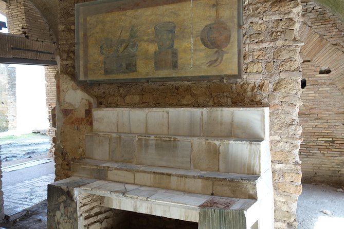 Ancient Ostia Antica Semi-Private Day Trip from Rome by Train with Guide - Baths of Neptune, Mosaics, and the Amphitheater for 3,500