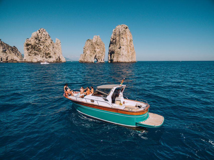 From Naples: Capri Boat Day Trip with Drinks - The Boat Cruise: Grottos, Faraglioni, Punta Carena, and a Swim Stop